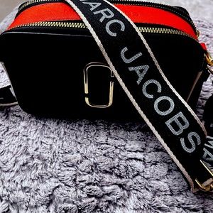 Marc Jacob’s cross body purse black, orange and cream. Fun purse.